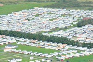 white and green houses on green grass field during daytime